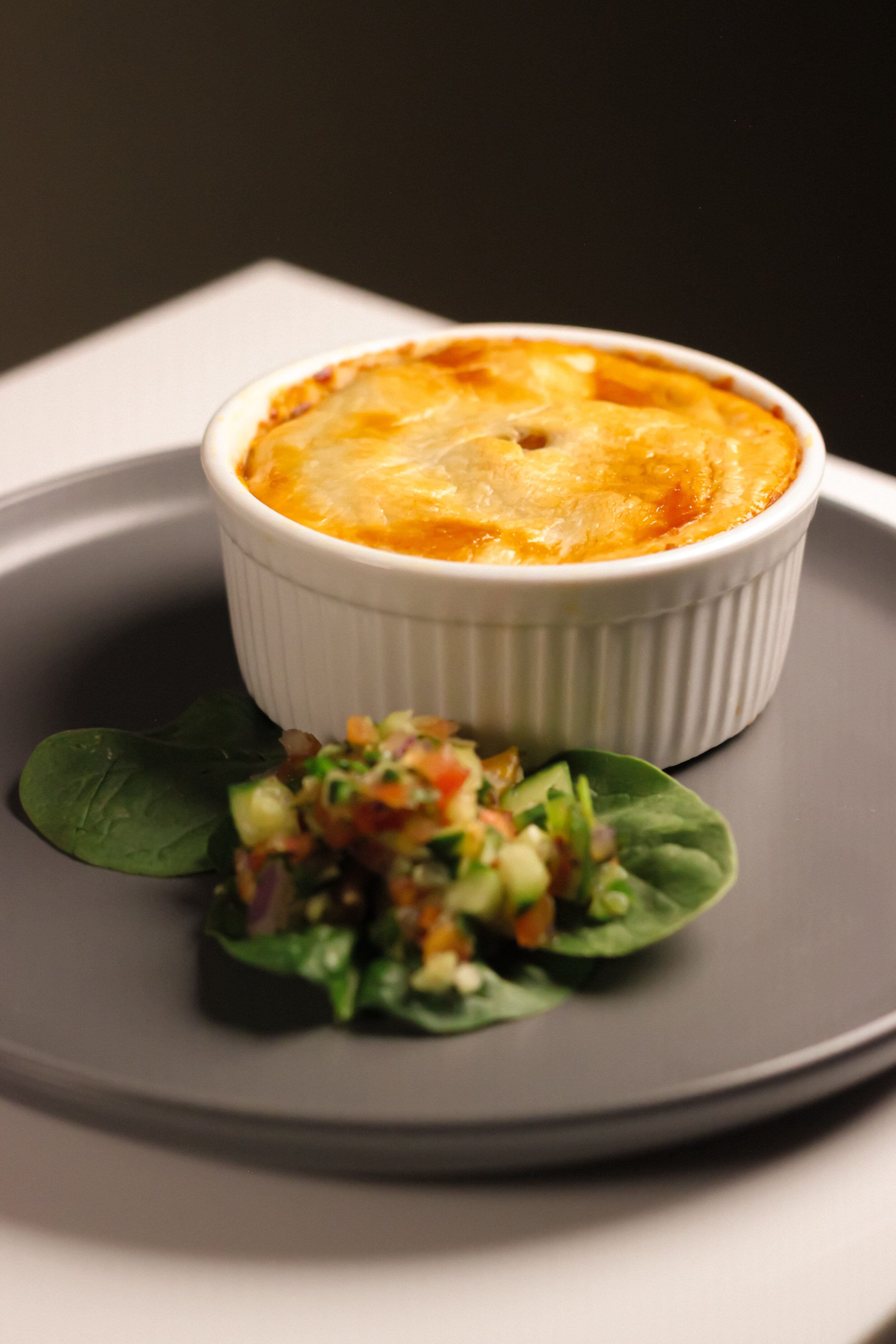 A bowl of food on a plate.